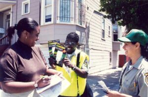 Corpsmembers handing out brochures on city street