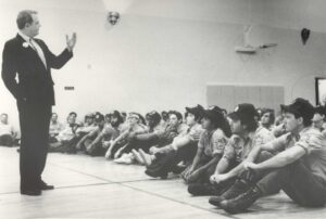 B.T. Collins talks to seated Corpsmembers in 1979