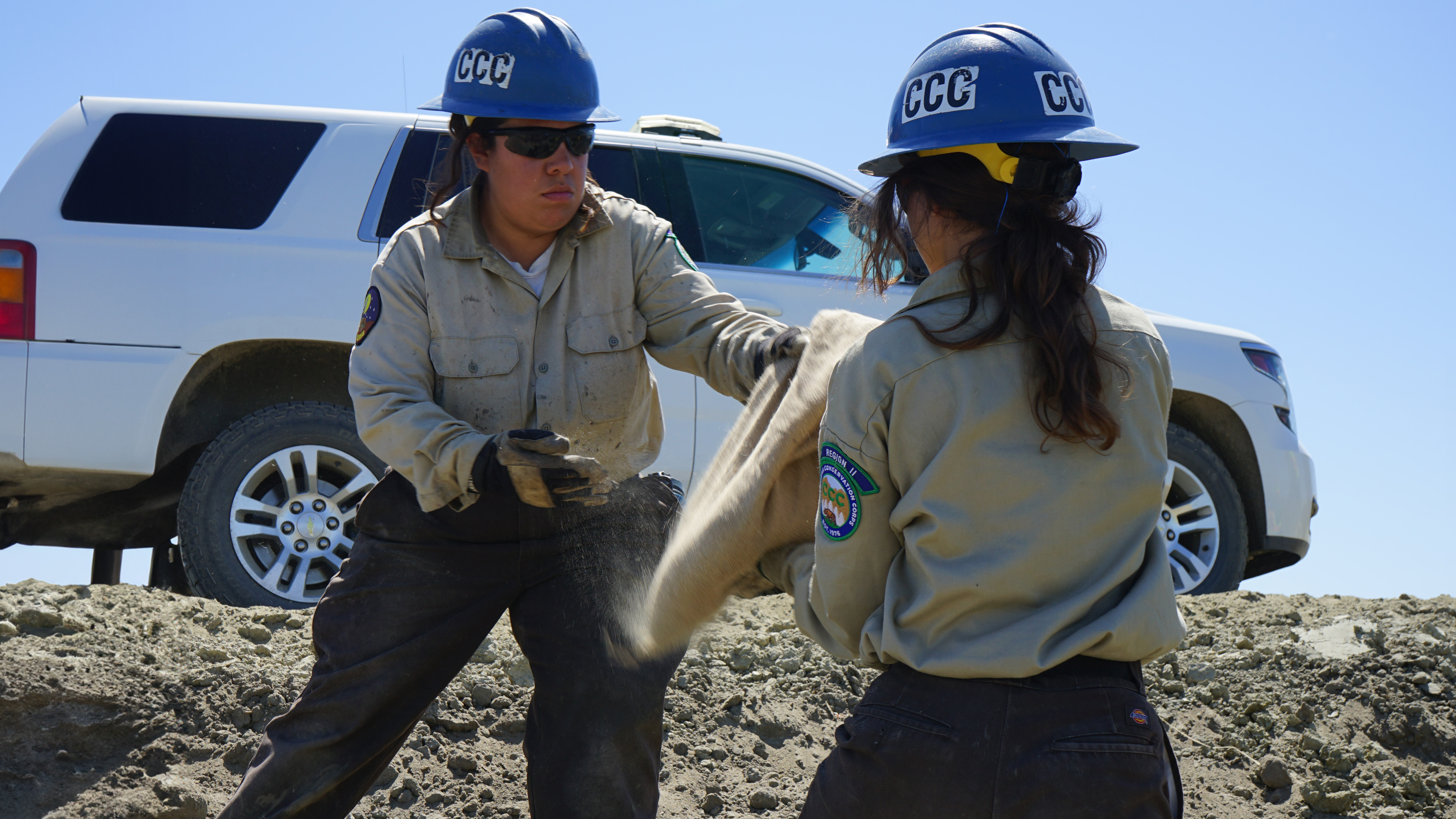 corpsmembers passing sandbags