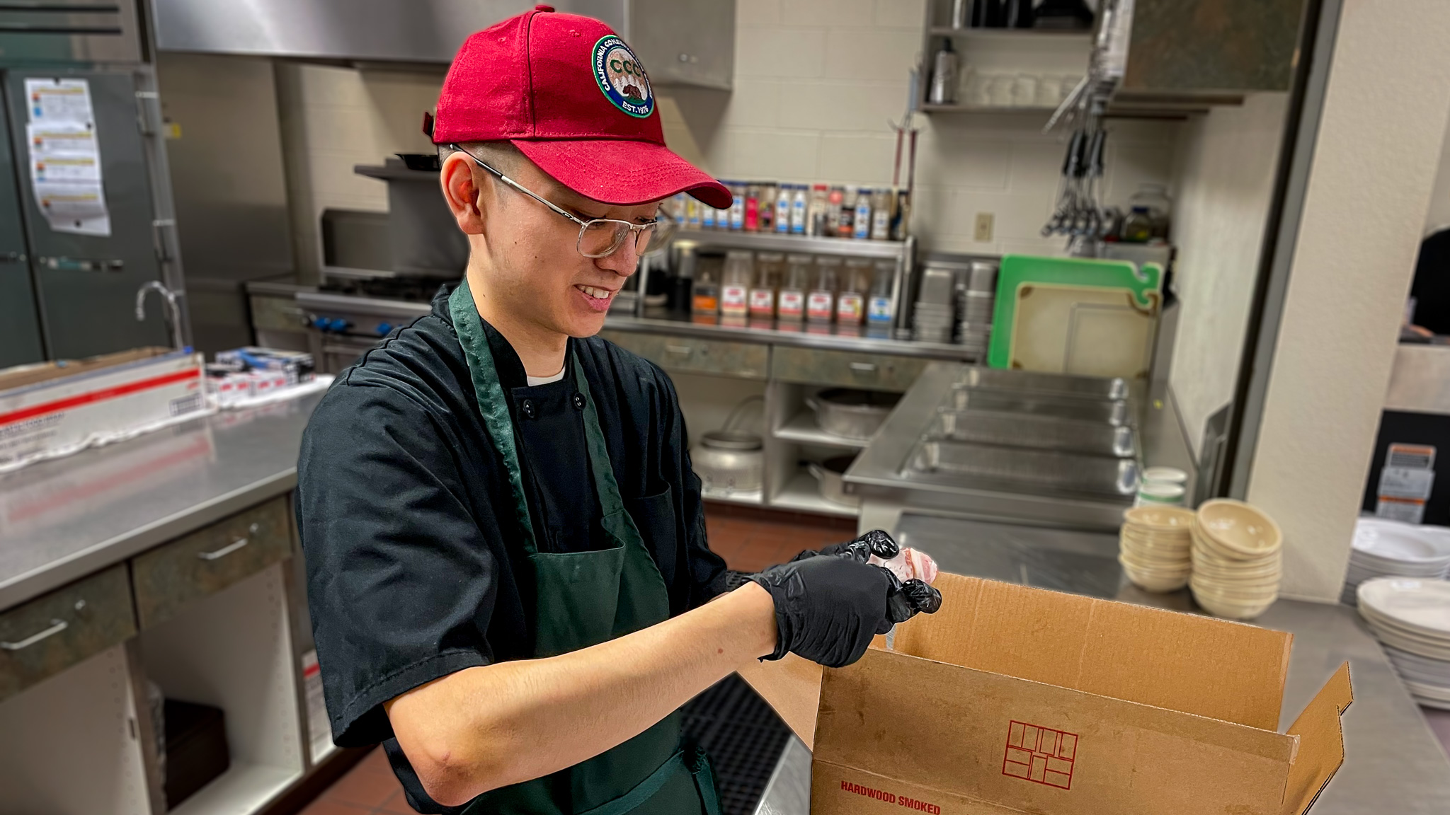 Marcus Kim preps food at the Greenwood Center