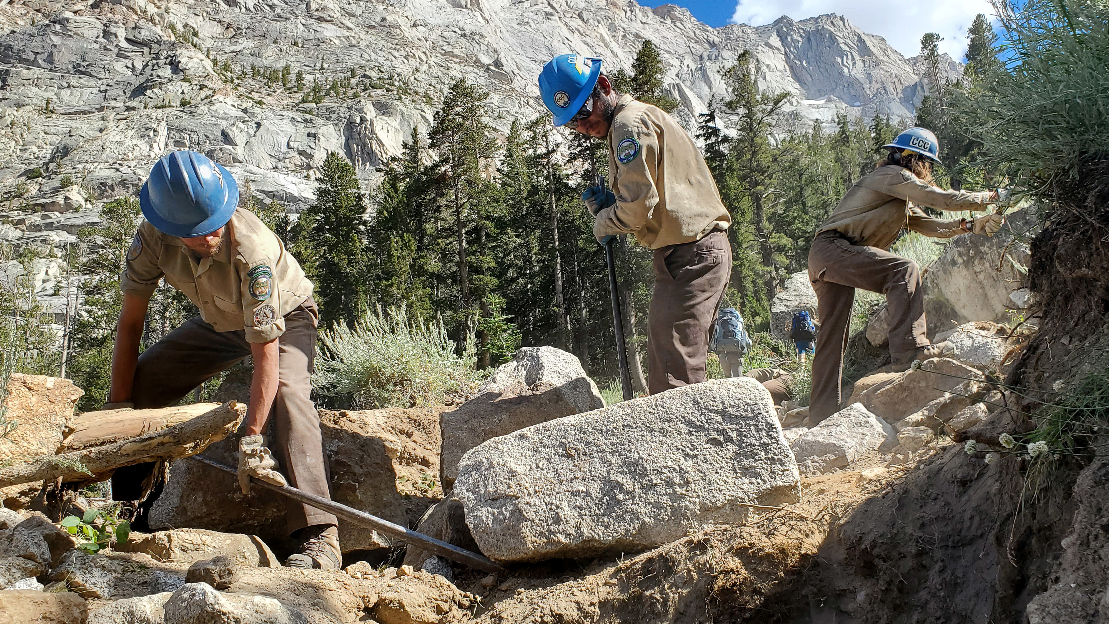 corpsmembers use rock bars to move giant rocks