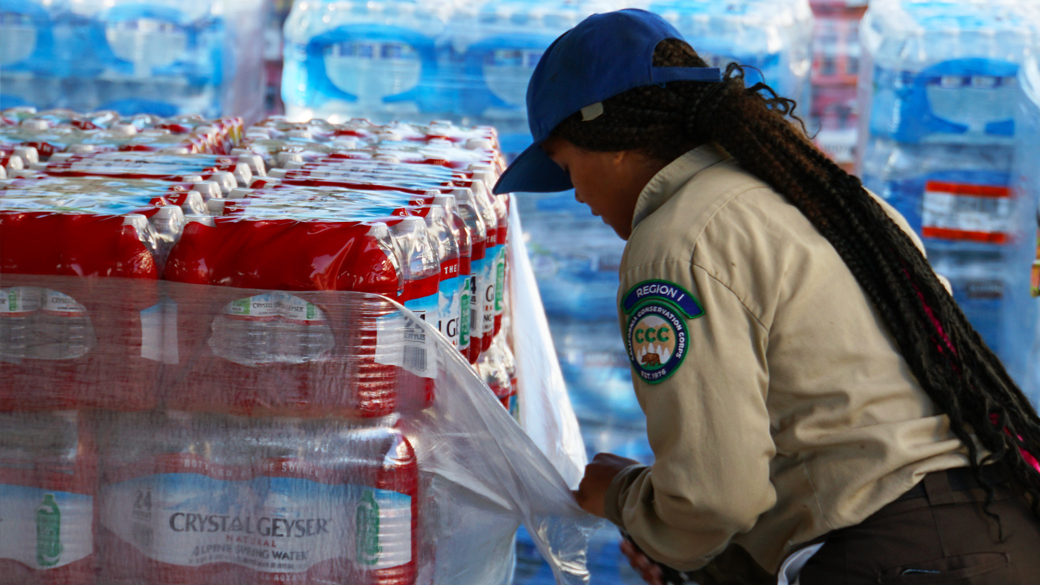 female using knife to cut plastic on a pallet