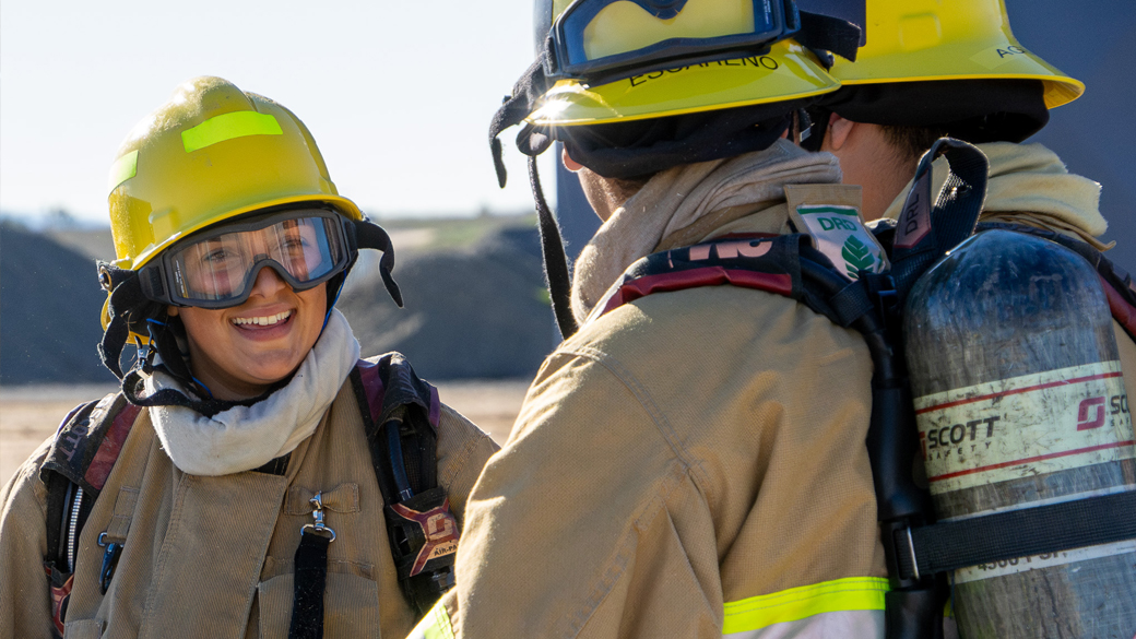 smiling female firefighter in turnout gear